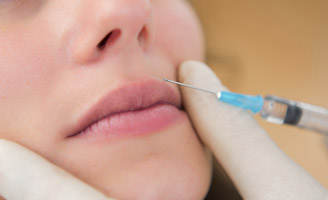 Woman having her upper lip injected with botox