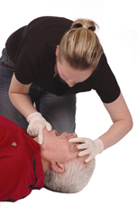 Woman tilting man’s head back using a finger and thumb grip on his chin (chin lift).