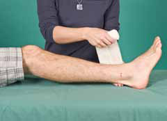 person placing bandage on leg