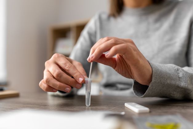 Person using rapid antigen test kit