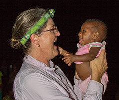 Sarah David holding a baby