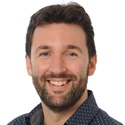 A headshot portrait of Thomas Volkman